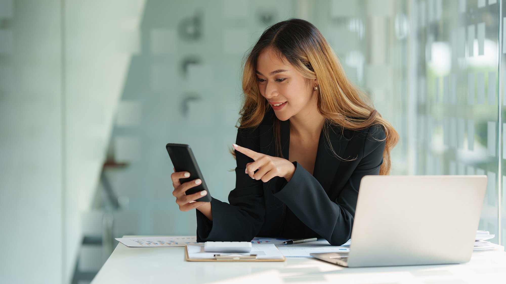 A businesswoman completes KYC using an online banking program in order to open a digital savings account. The definition of cyber security